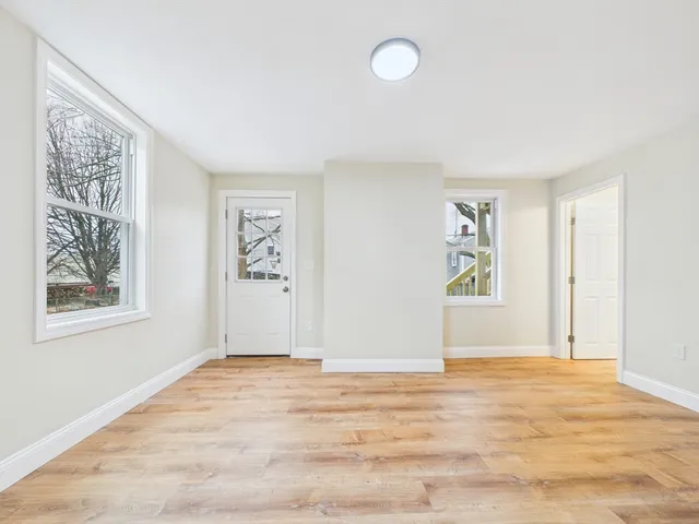 a view of livingroom with window and wooden floor