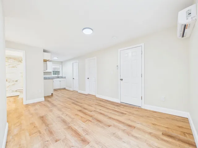 a view of a kitchen with wooden floor and a sink
