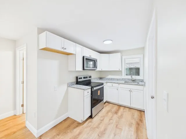 a kitchen with a sink stove and refrigerator