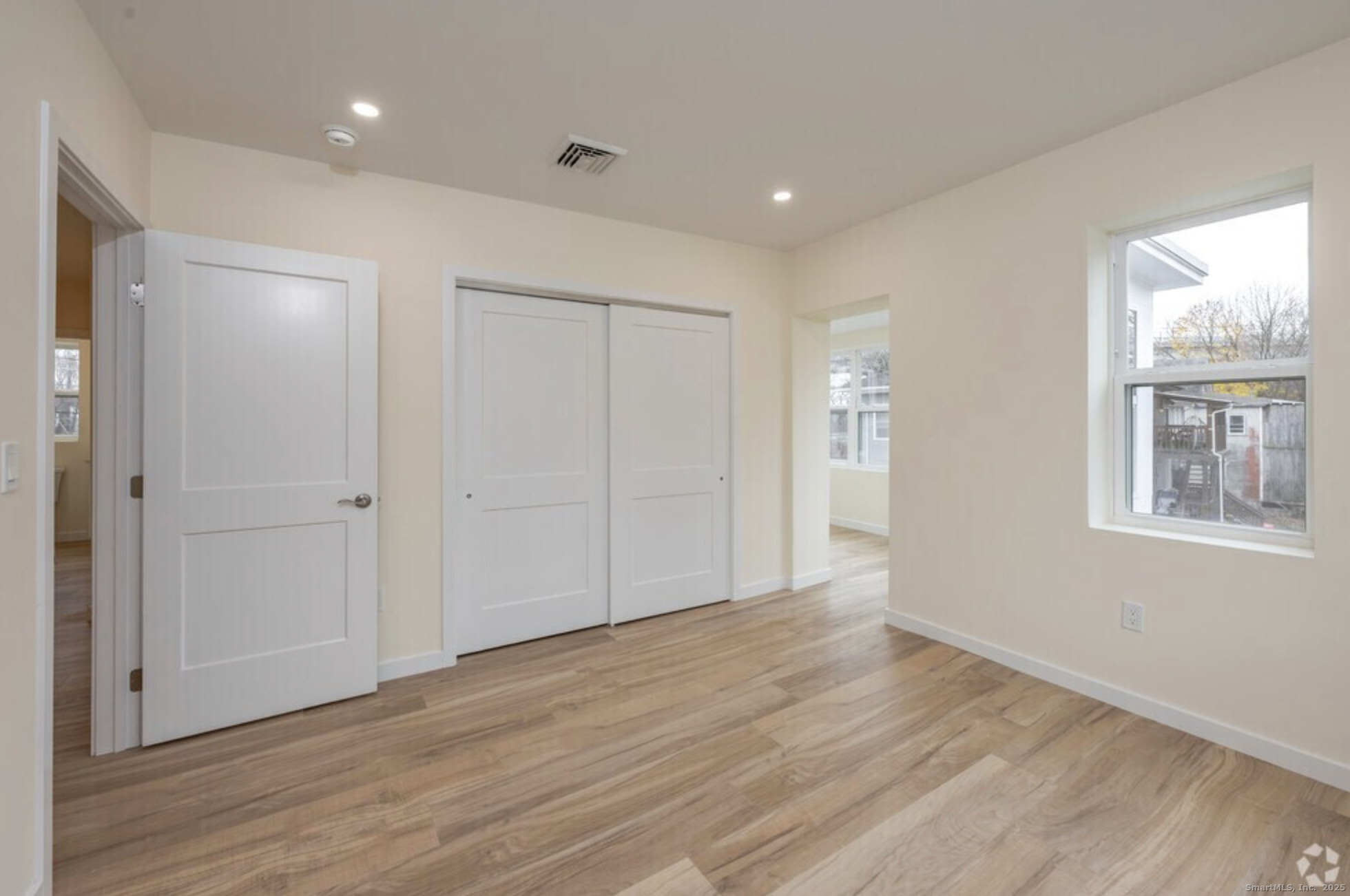 141 Bridge Street, Unit C Middletown, CT 06457 - Photo 5 of 12 a view of an empty room with wooden floor and a window