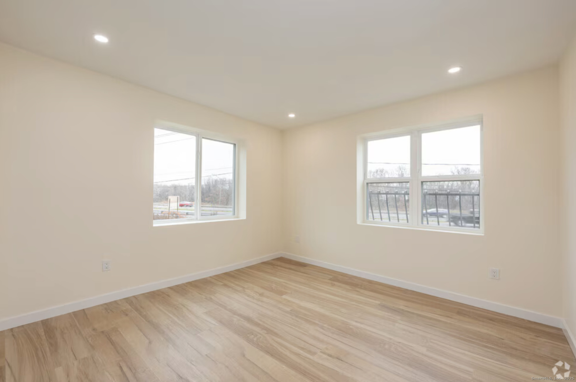 141 Bridge Street, Unit C Middletown, CT 06457 - Photo 7 of 12 an empty room with wooden floor and windows