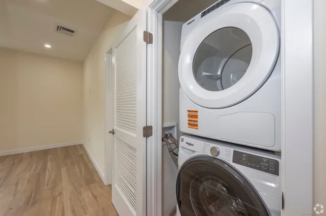 a view of a hallway with washer and dryer