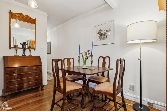 a dining room with furniture and wooden floor