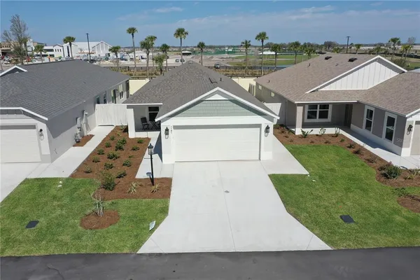 an aerial view of a house with yard