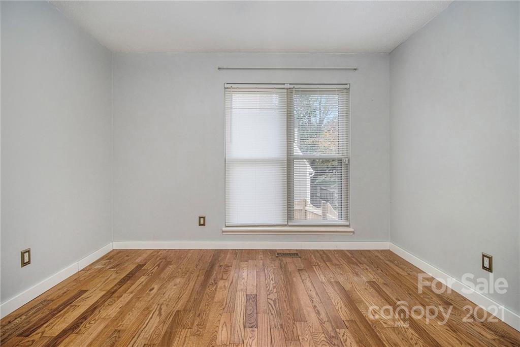 9618 Fairway Ridge Road Charlotte, NC 28277 - Photo 17 of 20 an empty room with wooden floor and windows
