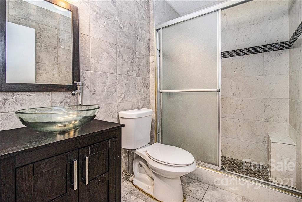 9618 Fairway Ridge Road Charlotte, NC 28277 - Photo 19 of 20 a bathroom with a granite countertop sink toilet and shower