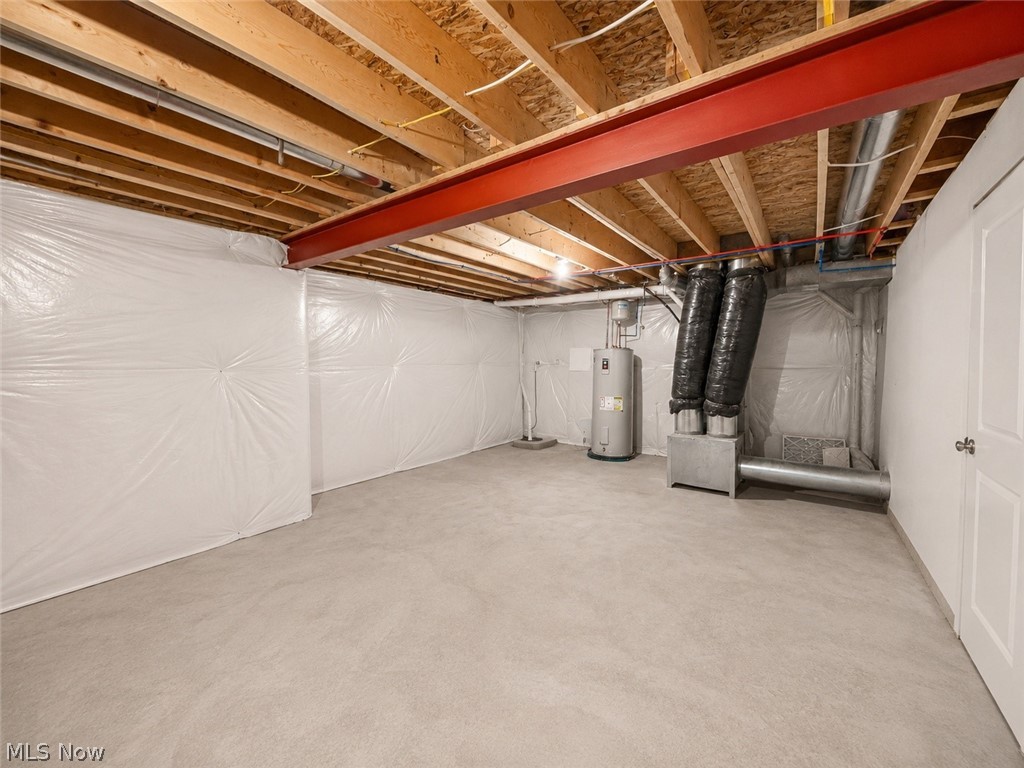 867 Starr Ridge Street Southeast Massillon, OH 44646 - Photo 24 of 29 Unfinished basement featuring a concrete floor, insulated walls, exposed ceiling joists, and a red steel support beam