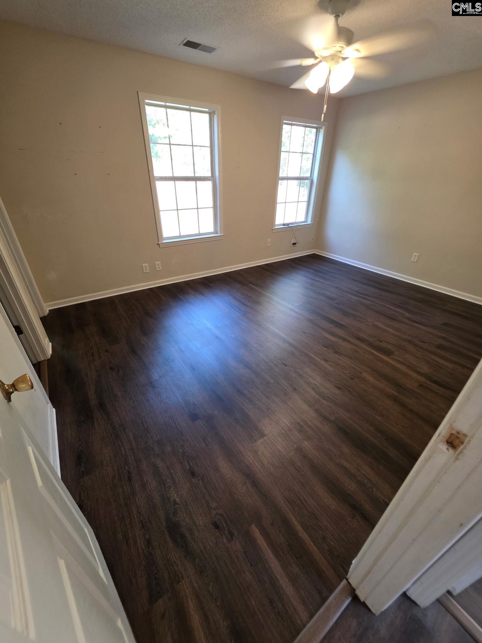 900 Watts Hill Road Lugoff, SC 29078 - Photo 18 of 33 a view of an empty room with wooden floor and window