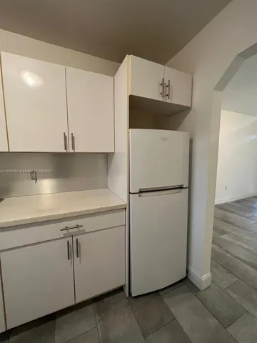 a utility room with cabinets washer and dryer