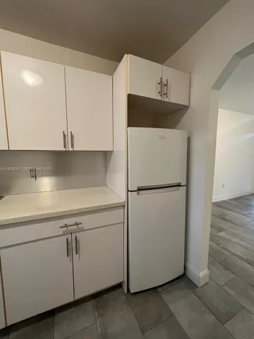 a utility room with cabinets washer and dryer
