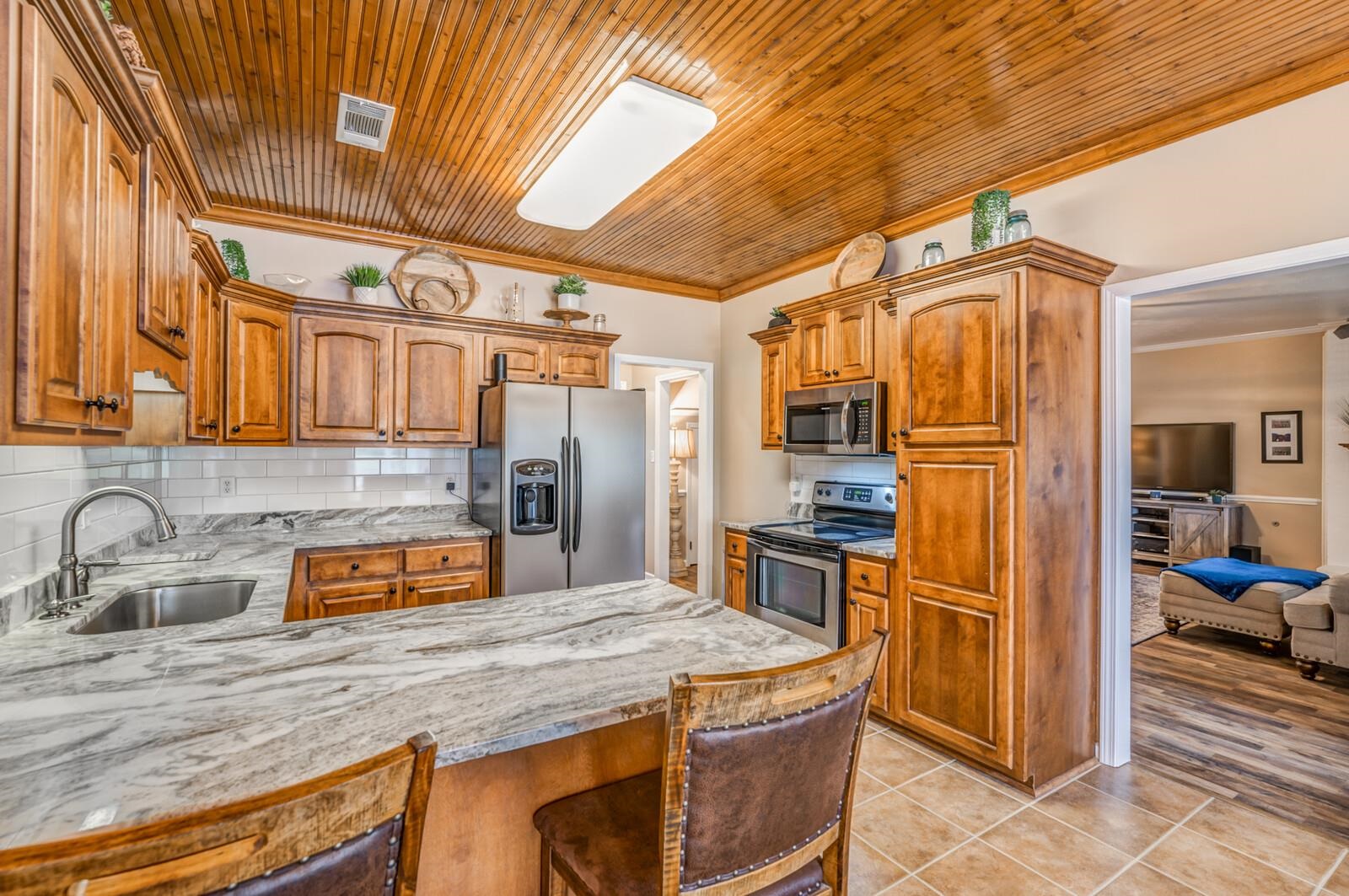 8649 Rankin Branch Road Millington, TN 38053 - Photo 9 of 34 Kitchen with tasteful backsplash, wood ceiling, light hardwood / wood-style floors, appliances with stainless steel finishes, and sink