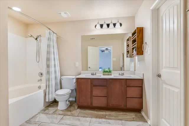 a bathroom with a bathtub sink and mirror