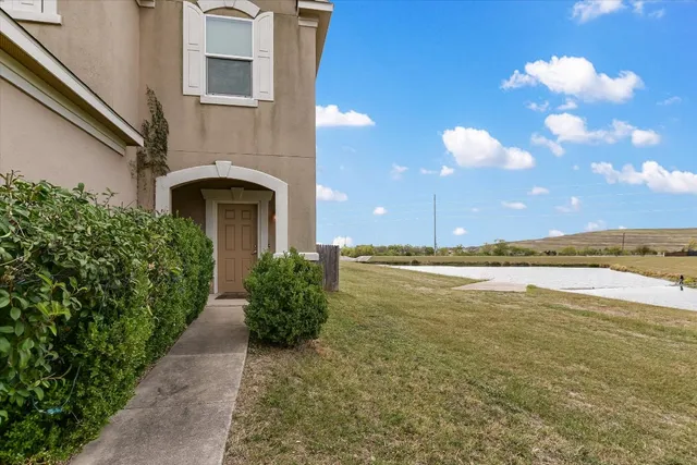 a view of an ocean with a floor to ceiling window and potted plants