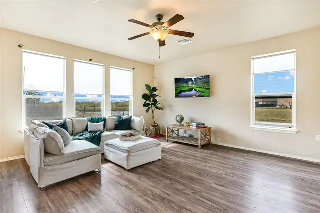 a living room with furniture and a large window