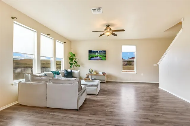 a living room with furniture and a large window