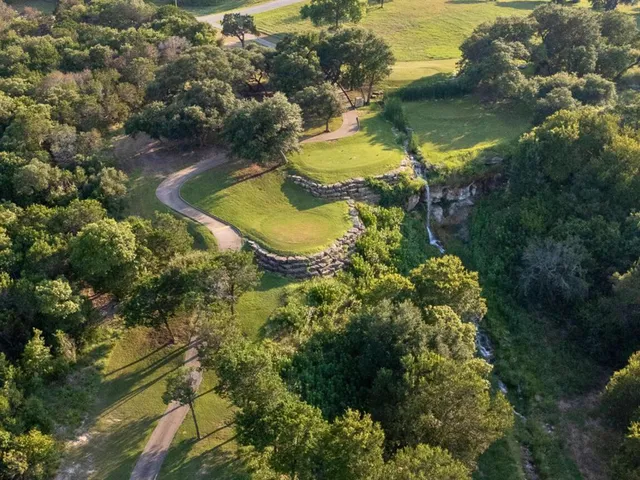 an aerial view of residential houses with outdoor space