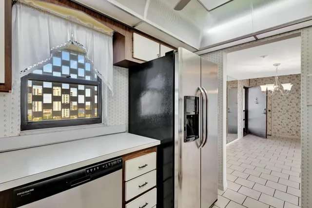 a kitchen with a refrigerator and a stove