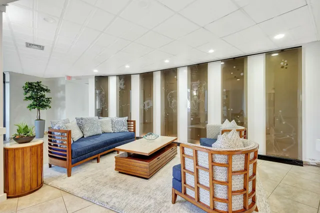 a living room with furniture and a potted plant