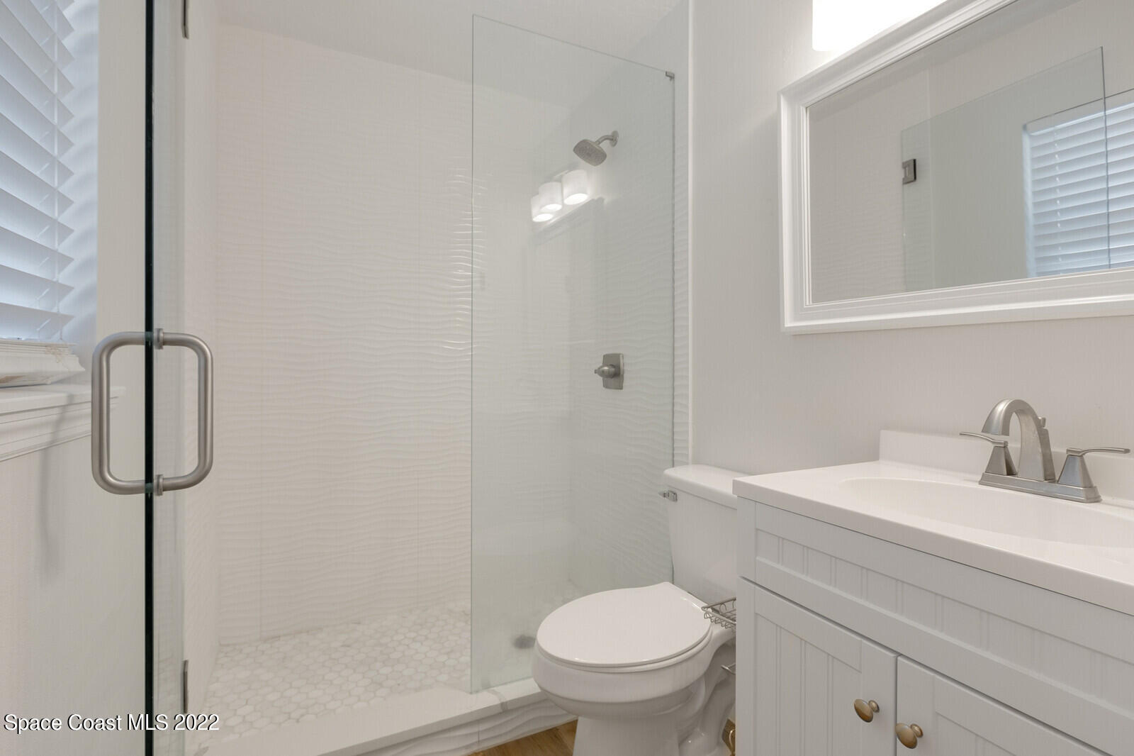 2834 Rheims Avenue Melbourne, FL 32935 - Photo 16 of 19 a bathroom with a granite countertop sink toilet and shower