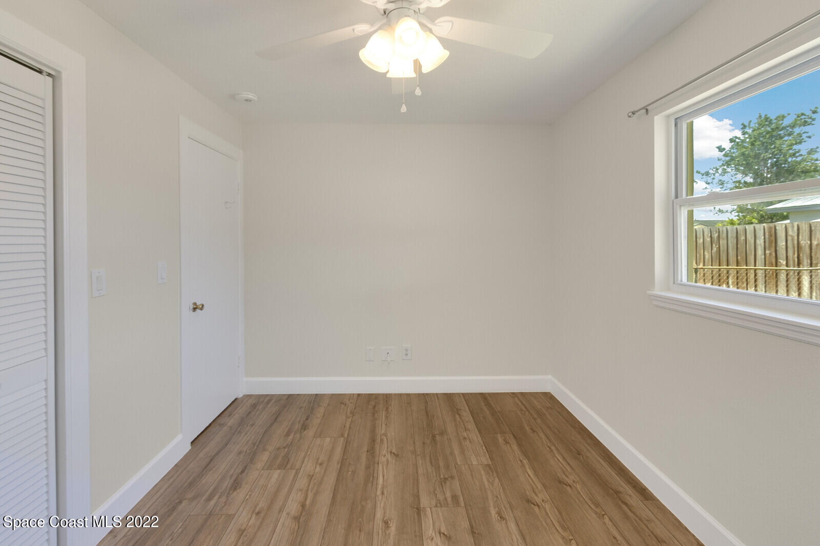 2834 Rheims Avenue Melbourne, FL 32935 - Photo 17 of 19 a view of a room with wooden floor and a window