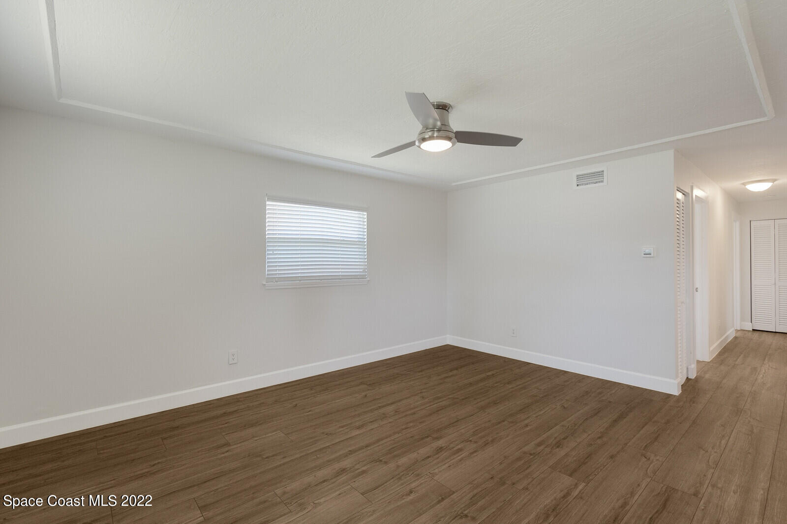2834 Rheims Avenue Melbourne, FL 32935 - Photo 4 of 19 a view of empty room with wooden floor