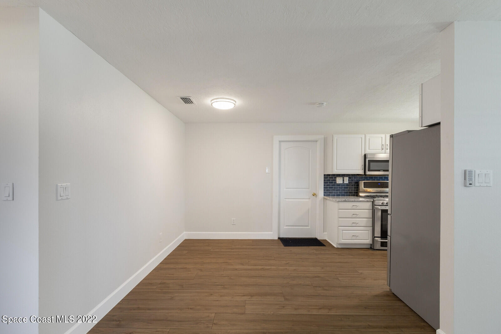 2834 Rheims Avenue Melbourne, FL 32935 - Photo 6 of 19 a view of a kitchen with a refrigerator a stove top oven and refrigerator