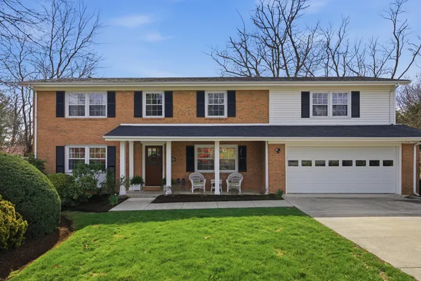 a view of a house with backyard and porch