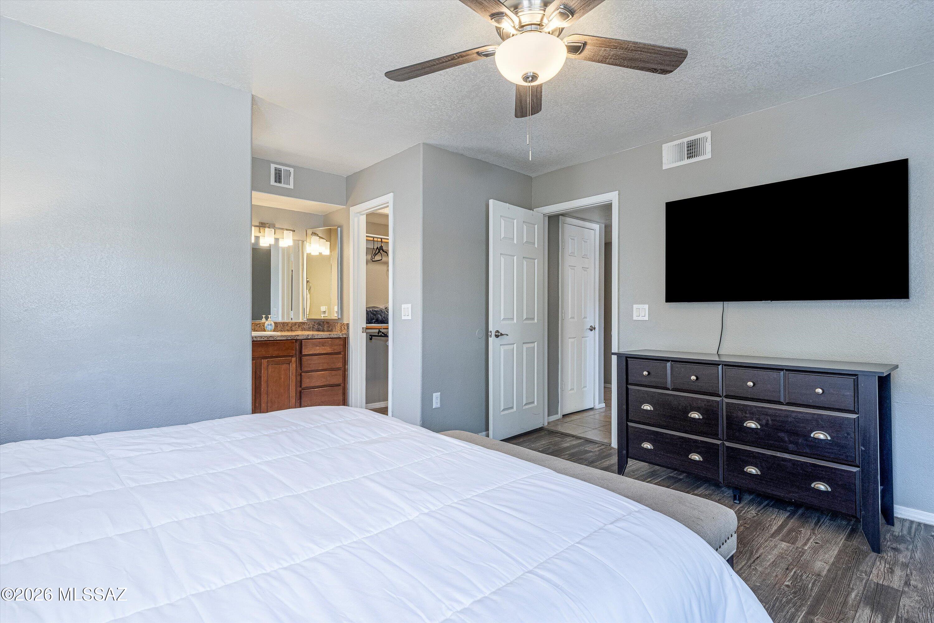 5855 North Kolb Road, Unit 8106 Tucson, AZ 85750 - Photo 18 of 34 a bedroom with a bed and a flat screen tv