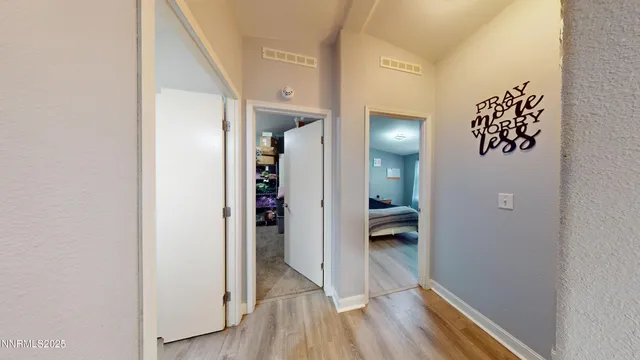 a view of hallway with wooden floor