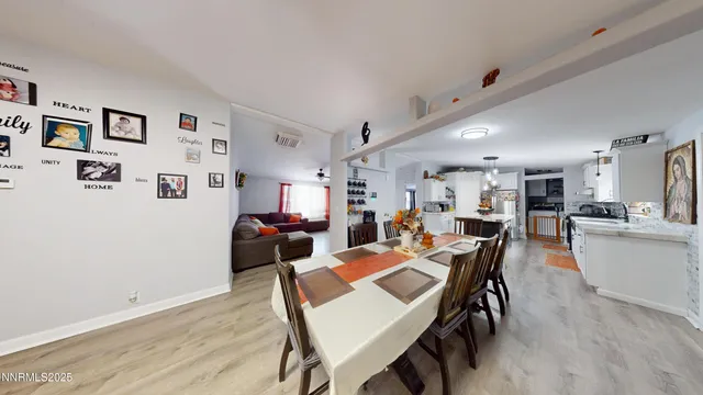 a view of a dining room with furniture and a potted plant
