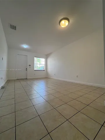 a view of kitchen with furniture and refrigerator