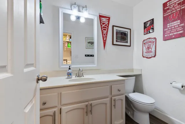 a bathroom with a toilet sink and mirror
