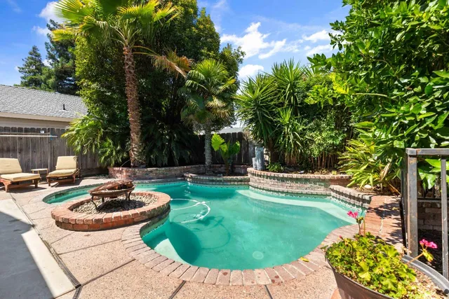 a view of a backyard with swimming pool
