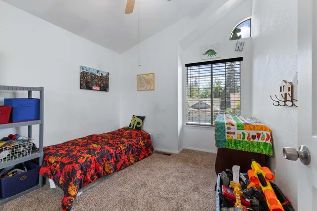 a bedroom with a bed and a window