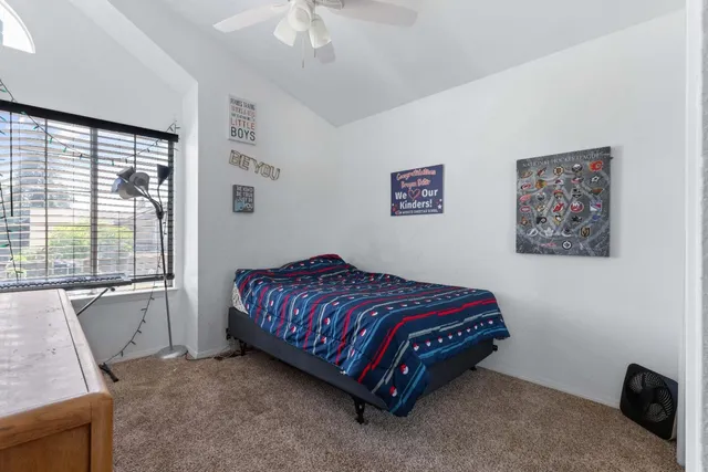 a bedroom with a bed and a window