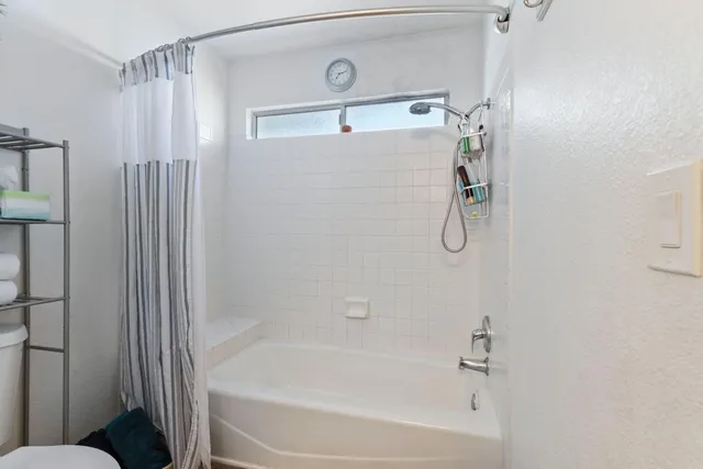 a bathroom with a shower and a bath tub