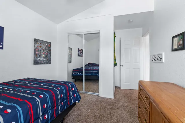 a bedroom with a bed and a view of bedroom