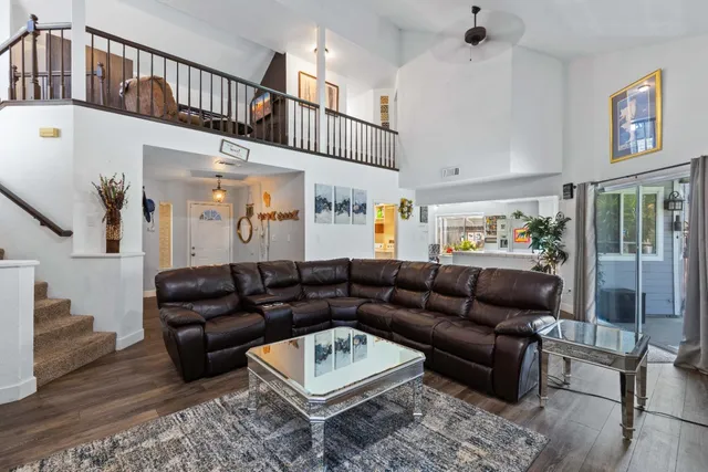 a living room with furniture and a book shelf