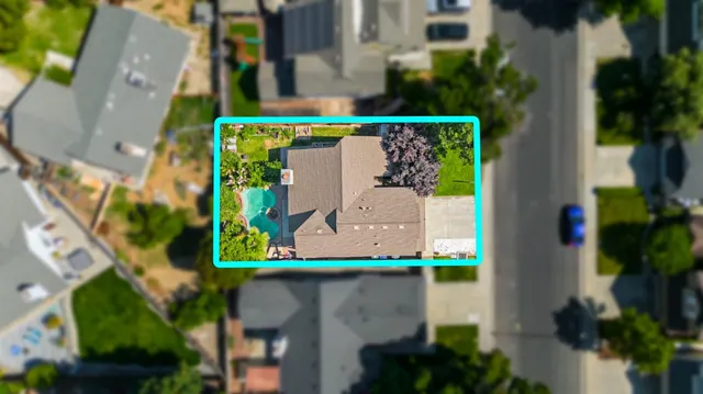 an aerial view of a house with a swimming pool
