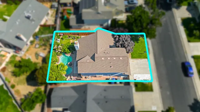 an aerial view of a house with a swimming pool