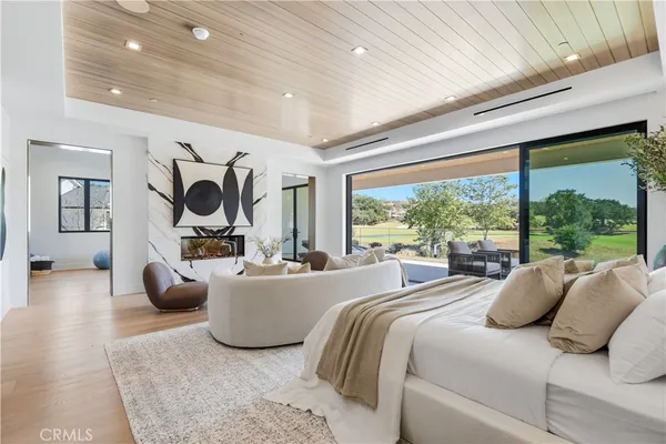 a bedroom with furniture and a large window