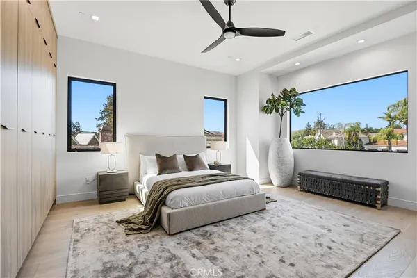 a bedroom with a bed potted plant with the view of bathroom