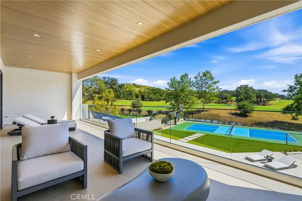 a swimming pool with outdoor seating and yard