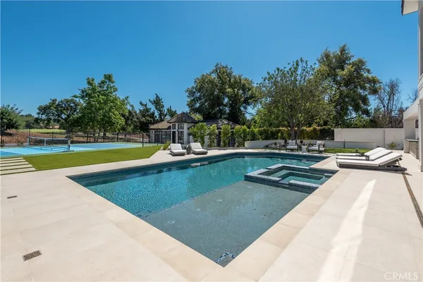 a view of a swimming pool with lounge chairs