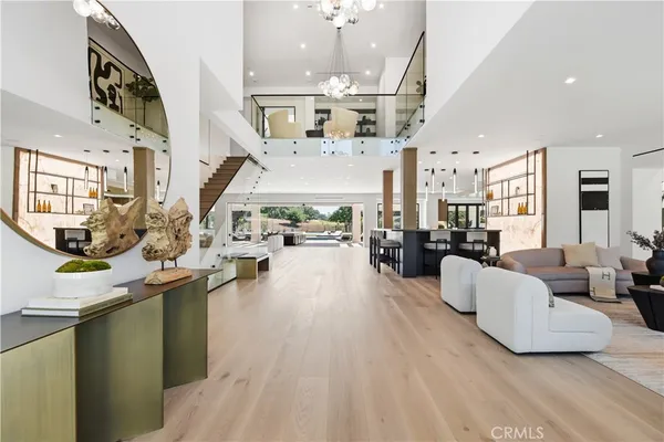 a living room with furniture and a chandelier