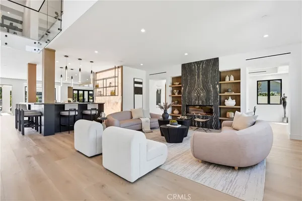 a living room with fireplace furniture and a chandelier