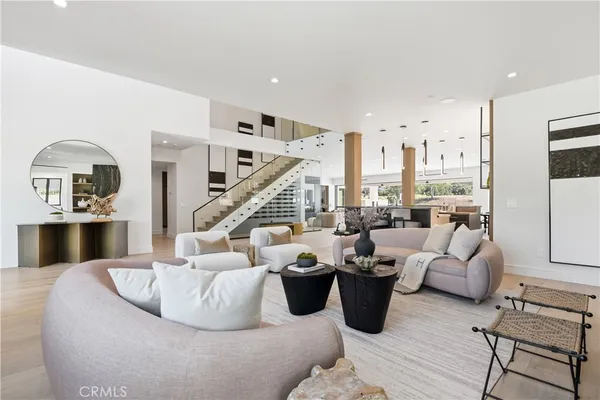 a living room with furniture and a view of kitchen