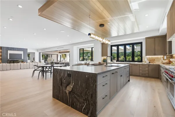 a large kitchen with stainless steel appliances granite countertop a lot of counter space and a sink