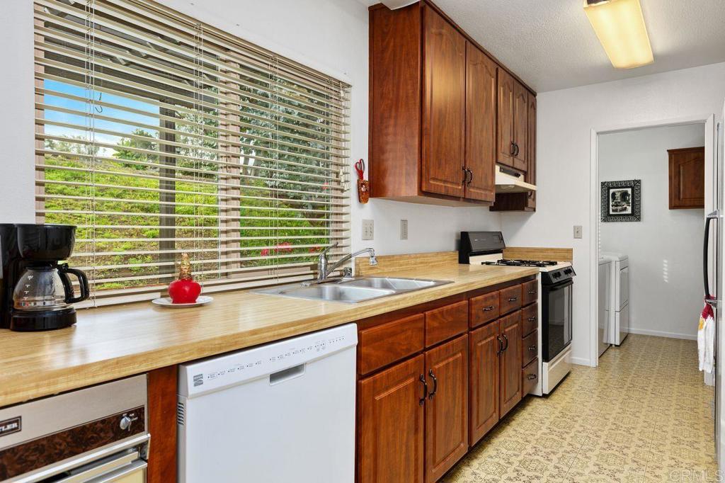 727 Nob Circle Vista, CA 92084 - Photo 12 of 39 a kitchen with stainless steel appliances wooden cabinets a stove and a refrigerator