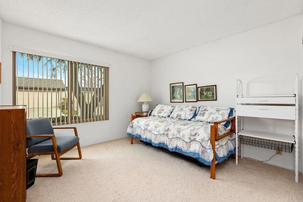 727 Nob Circle Vista, CA 92084 - Photo 21 of 39 a bedroom with a bed chair and a window